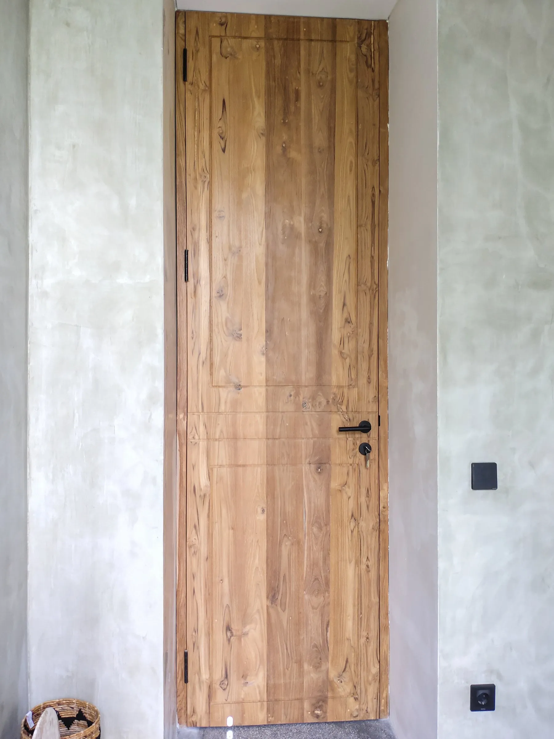 Full-height solid teak room door.