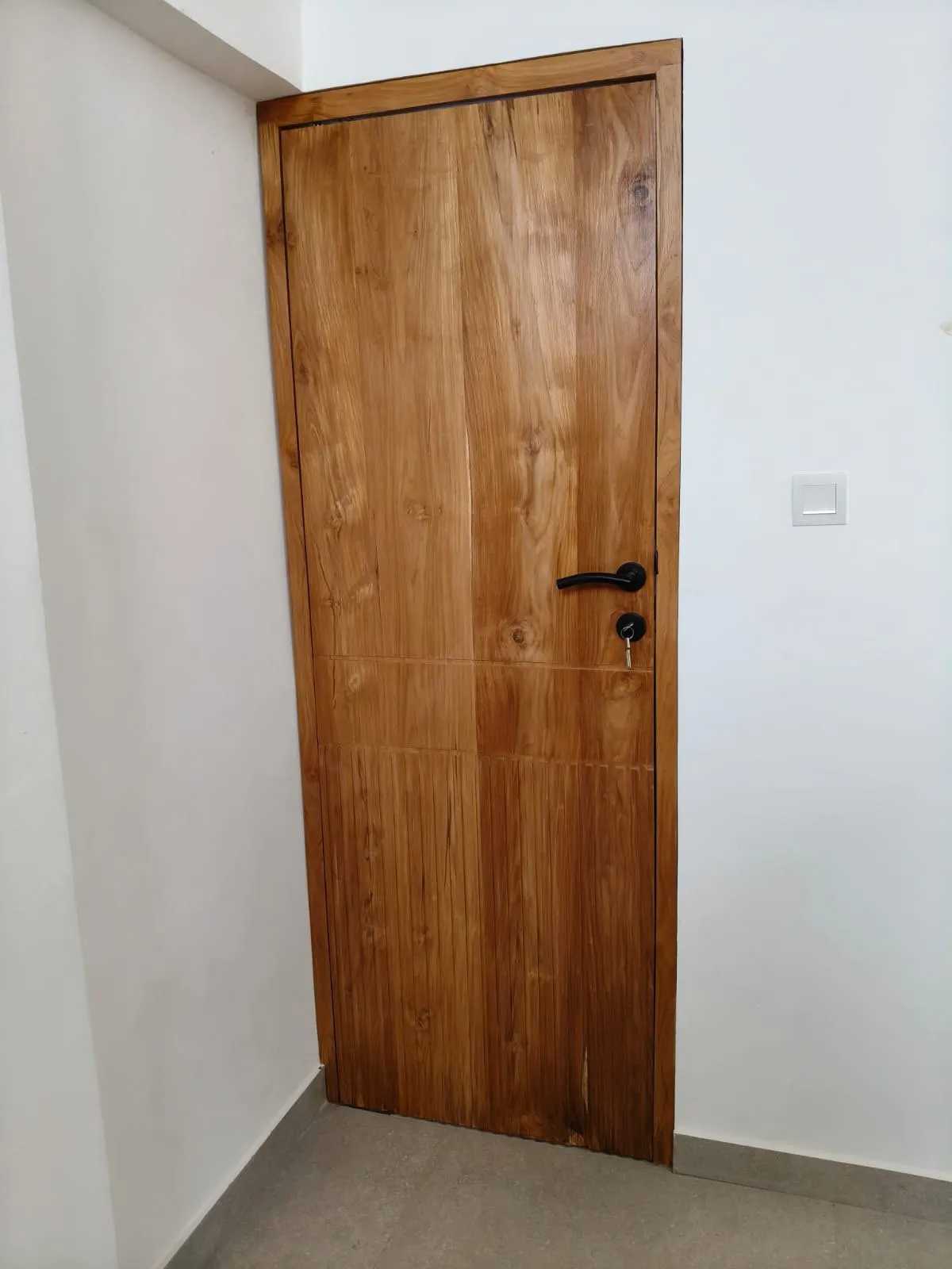 Solid teak door with teak frame.