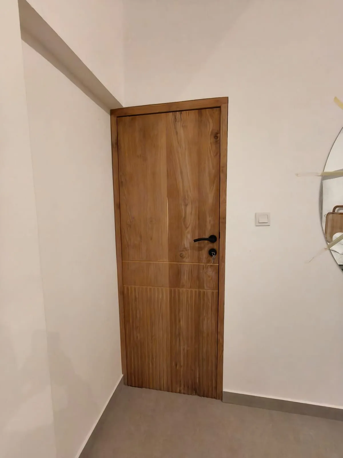 Solid teak door with teak frame.