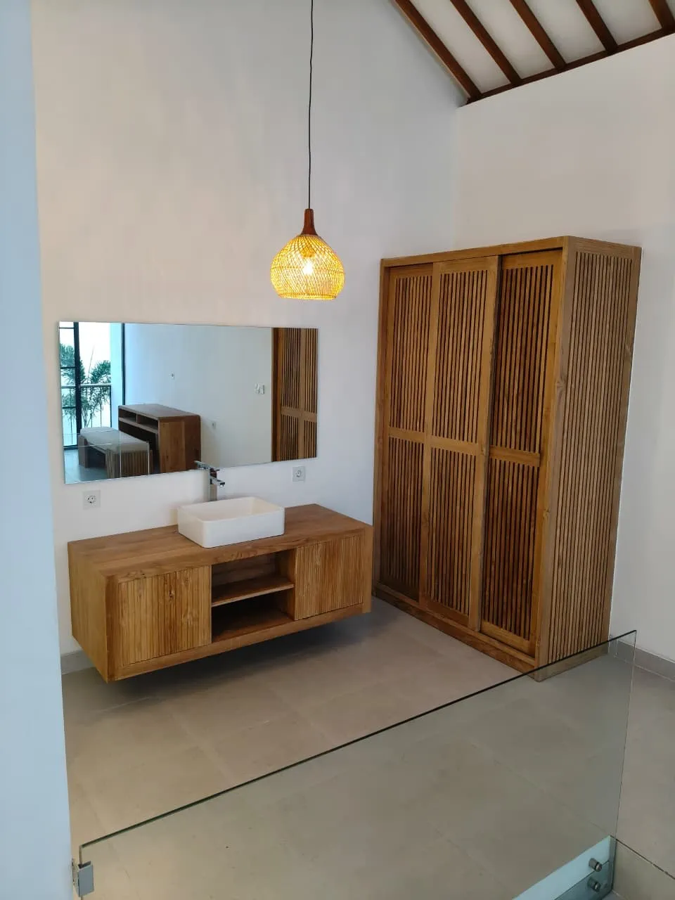 Teak vanity and wardrobe on an upper floor.